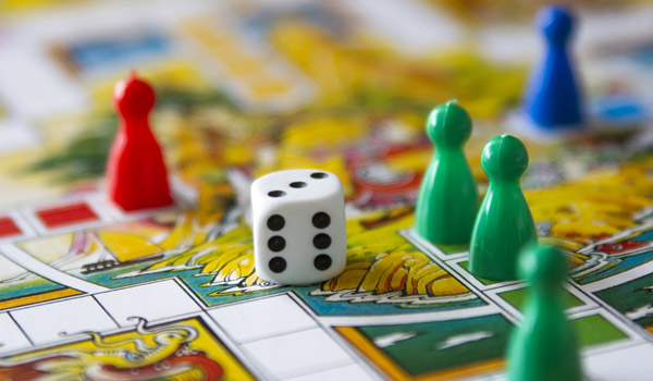 image of a board game board with pieces and a die