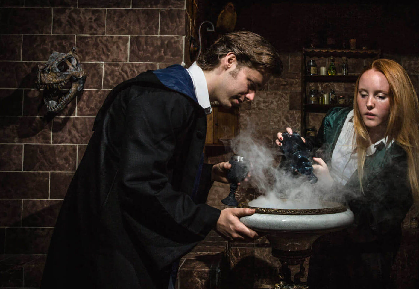 Witch and wizard standing over a smoking cauldron