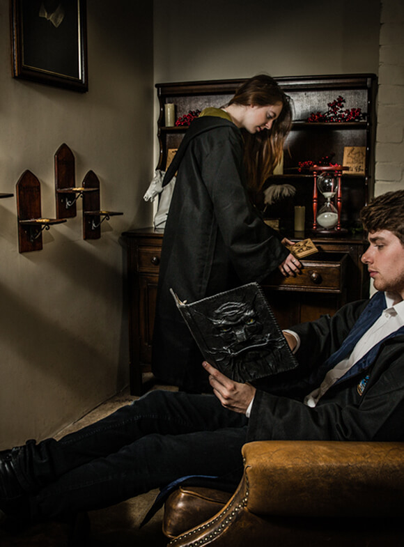 Photo of a man and woman inside an escape room, magical style